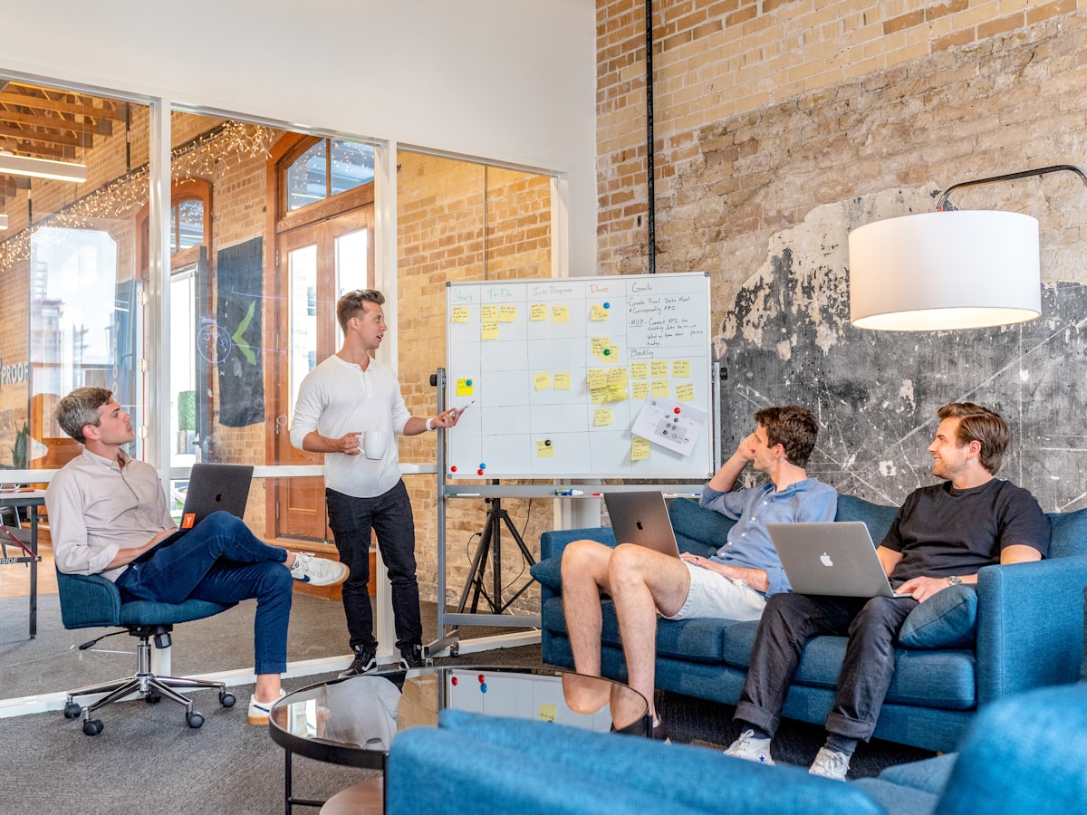 A business team planning work together around a whiteboard